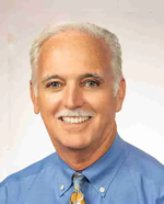 Dr. Dave De Rosier professional headshot in blue shirt and tie – Point Loma Dentist Smiling Dr. Dave De Rosier wearing a blue shirt and patterned tie, professional portrait against a light background – Point Loma Dentist